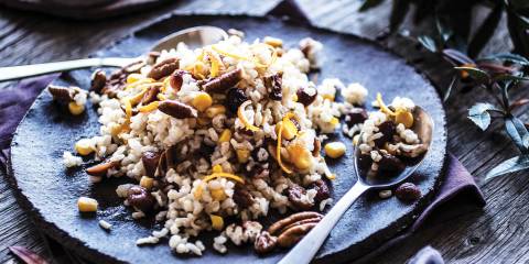 Thanksgiving Rice on a blue rustic plate with a blue toned background.
