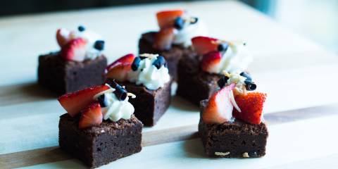 Miniature brownies topped with berries
