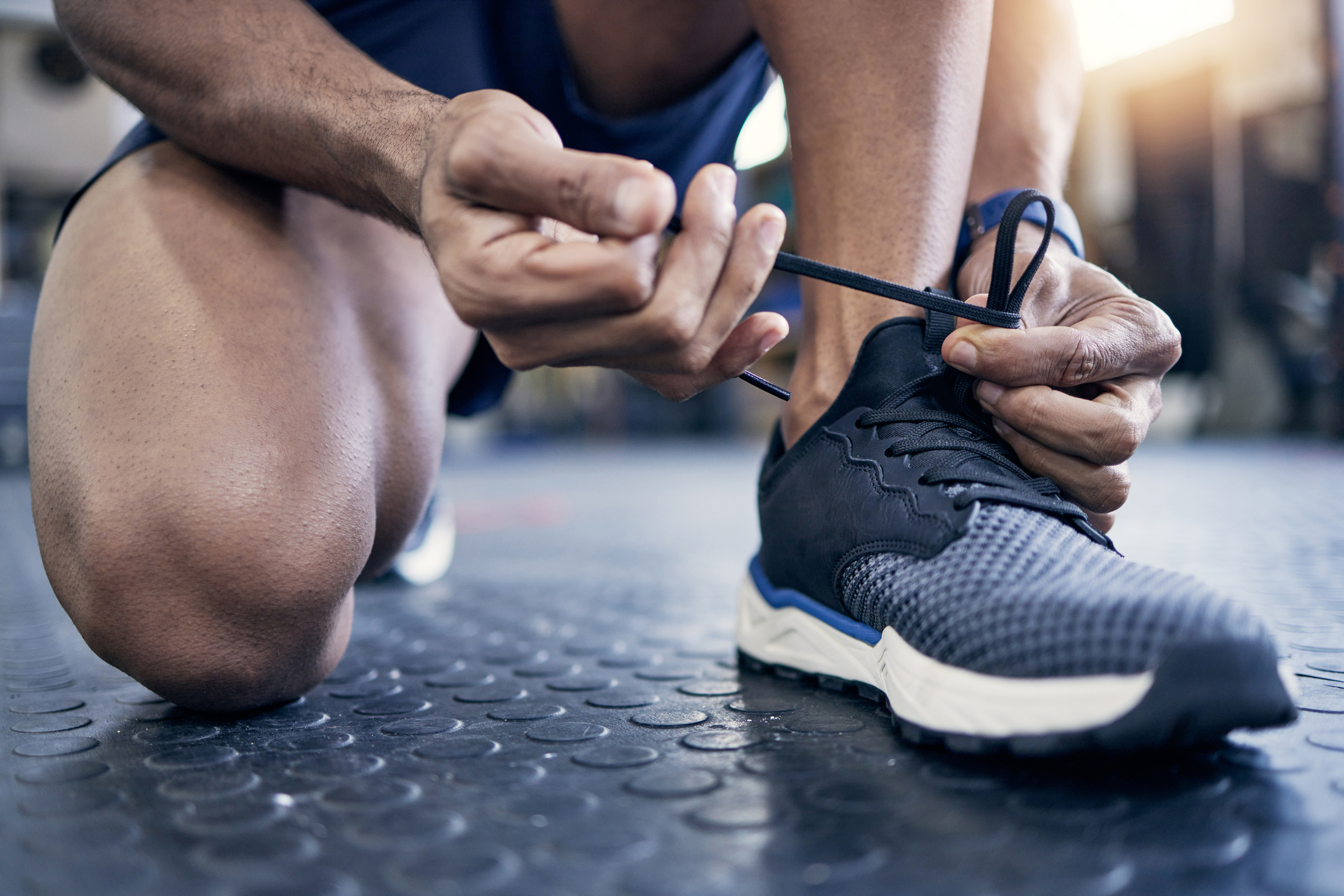 Man tying sneaker.