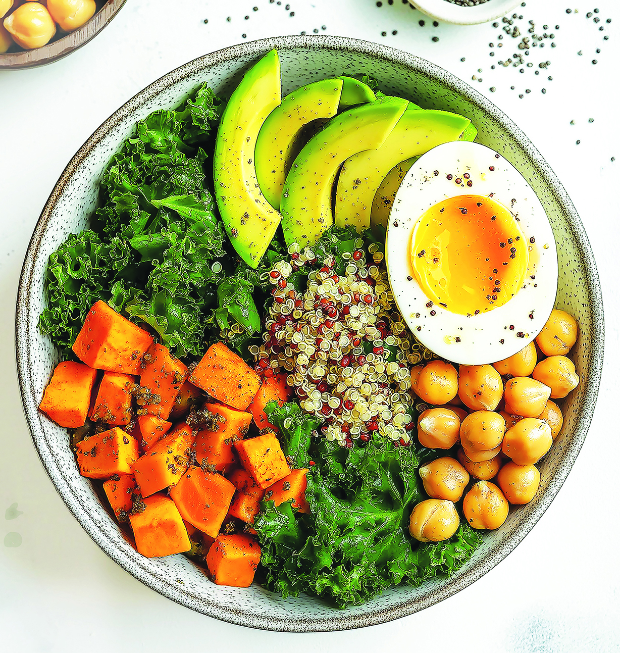Kale, quinoa, chickpea and sweet potato salad in a bowl.