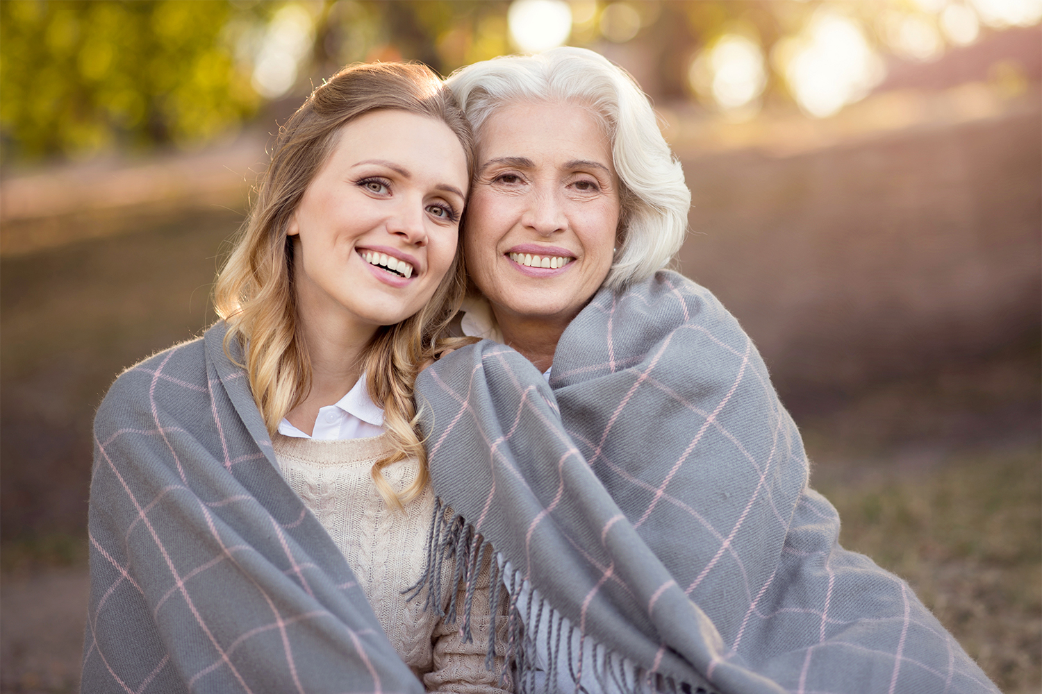 A young woman embraced by her older self