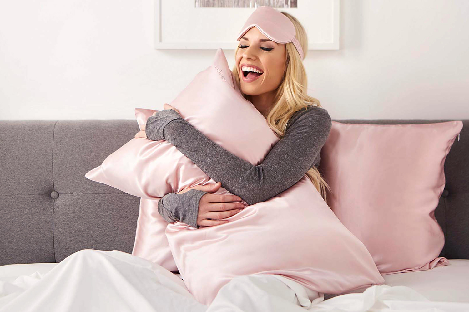 a woman hugging her pillows