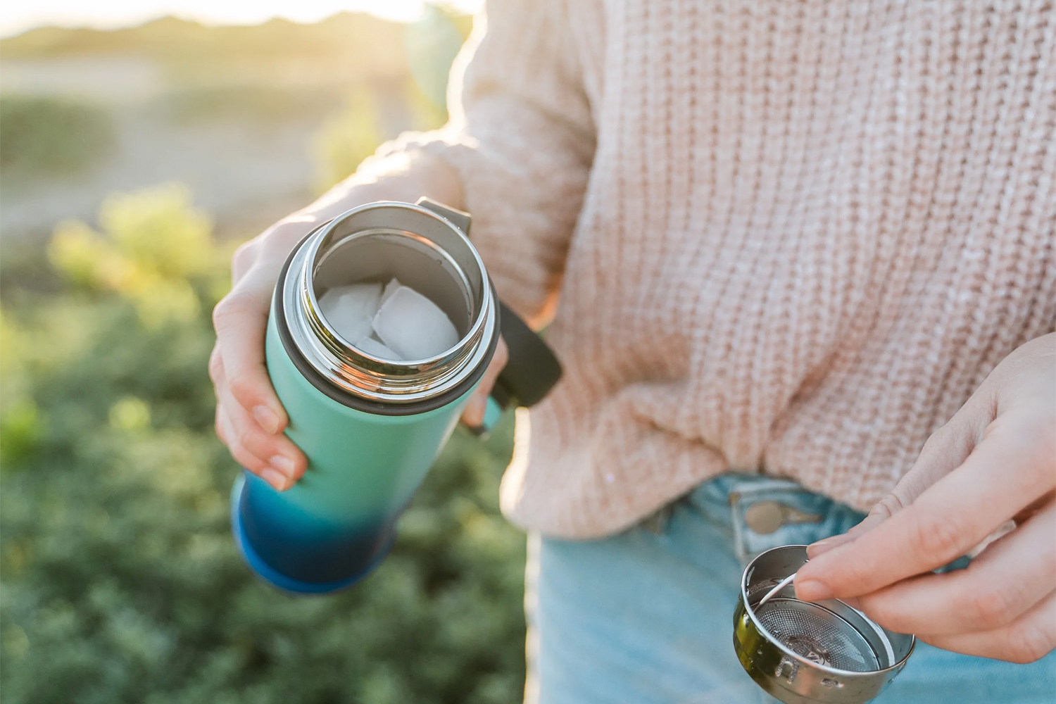 a woman detaching a strainer from her bottle