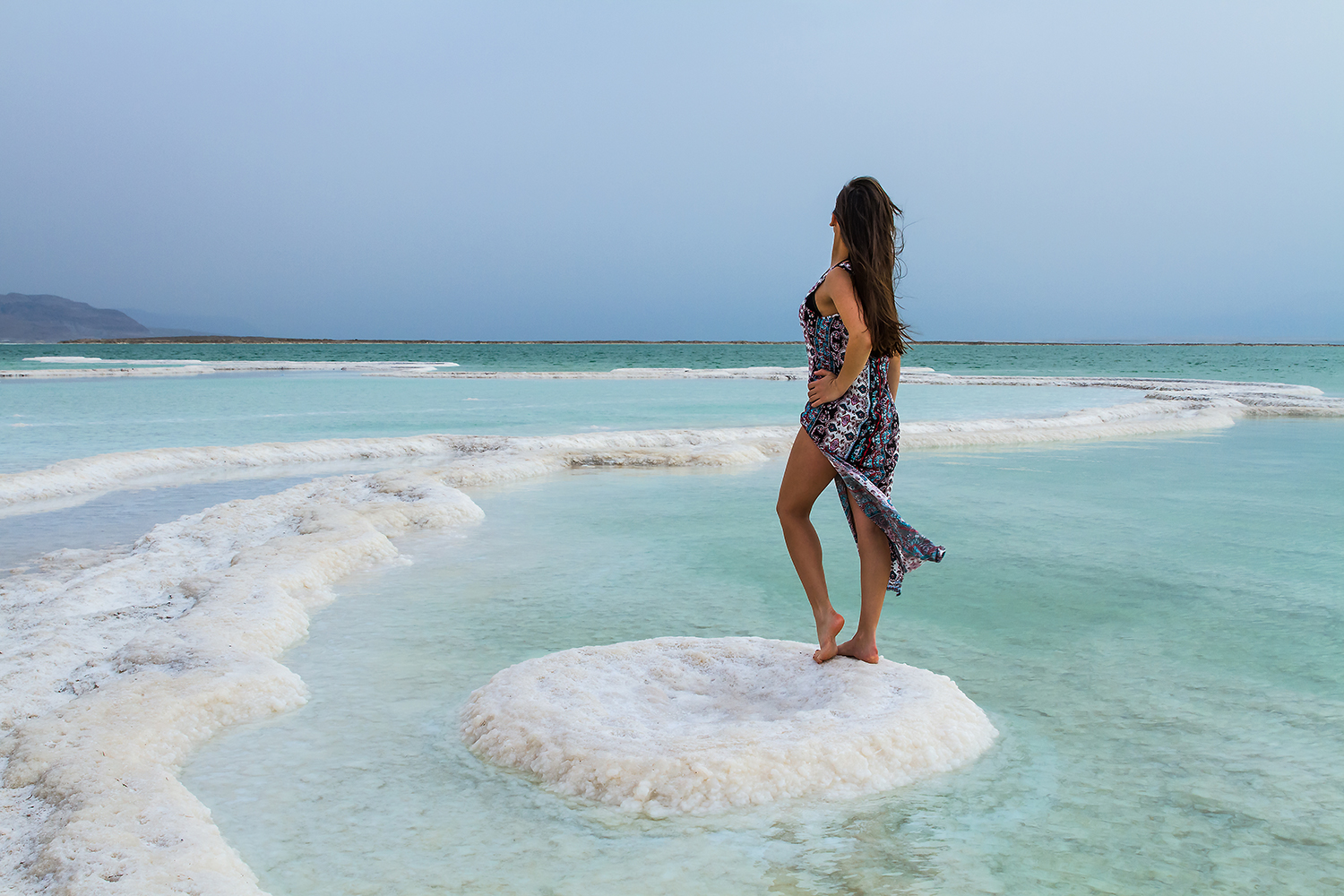 A healthy woman standing by the Dead Sea