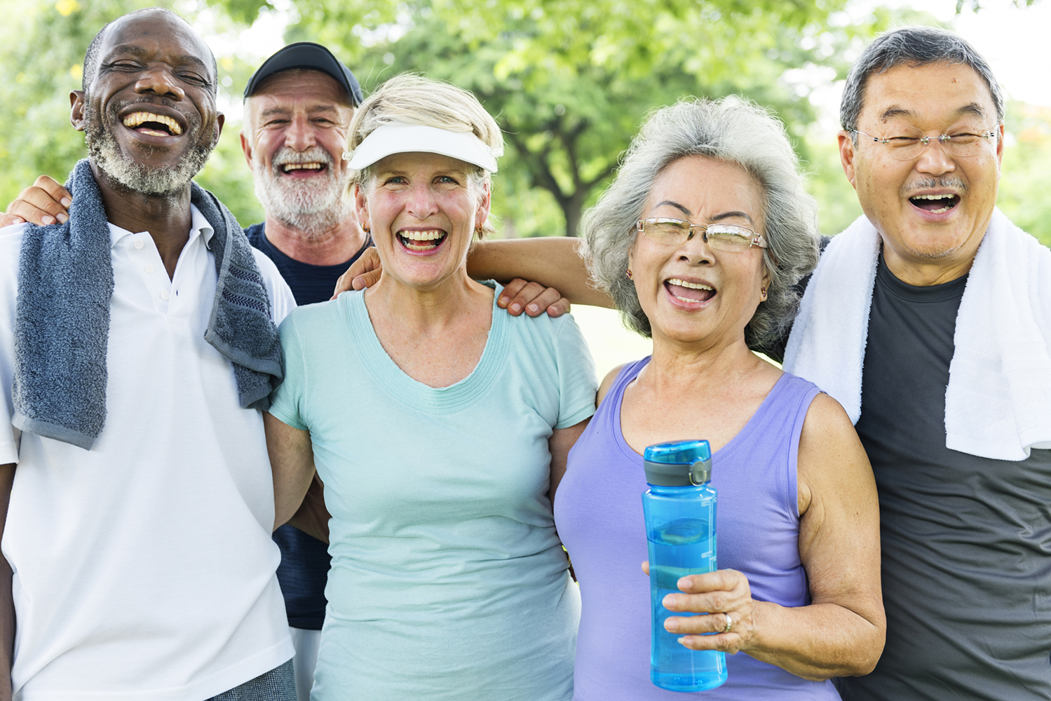 A group of smiling seniors ready to exercise.