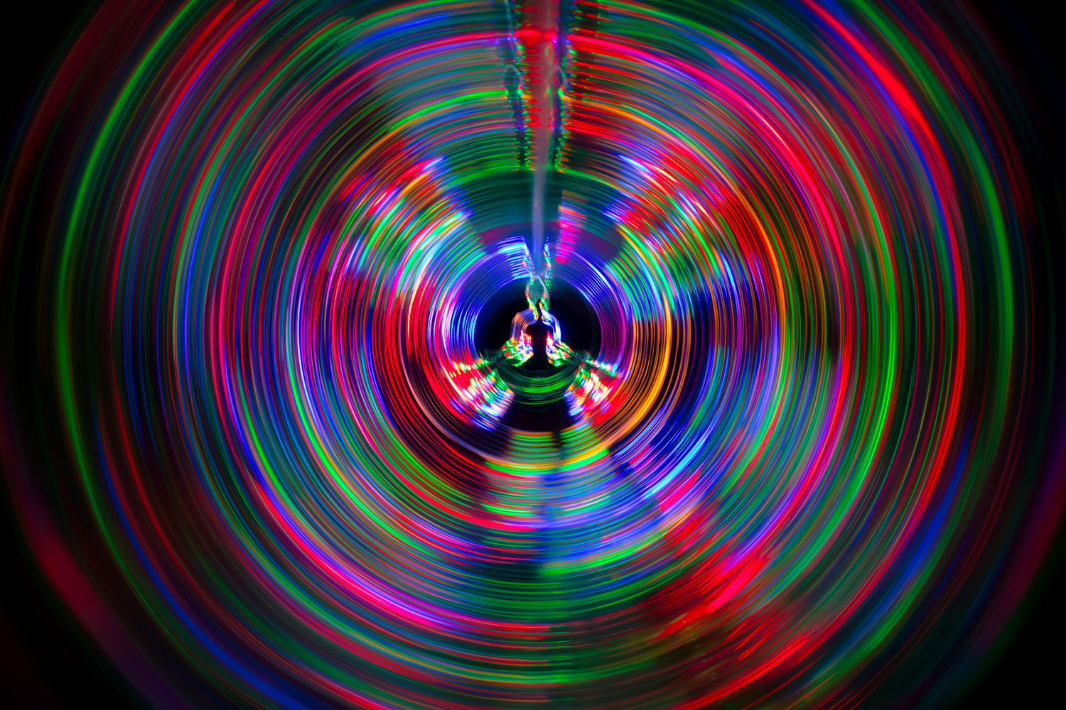 soundwaves of different color emanating from the dark