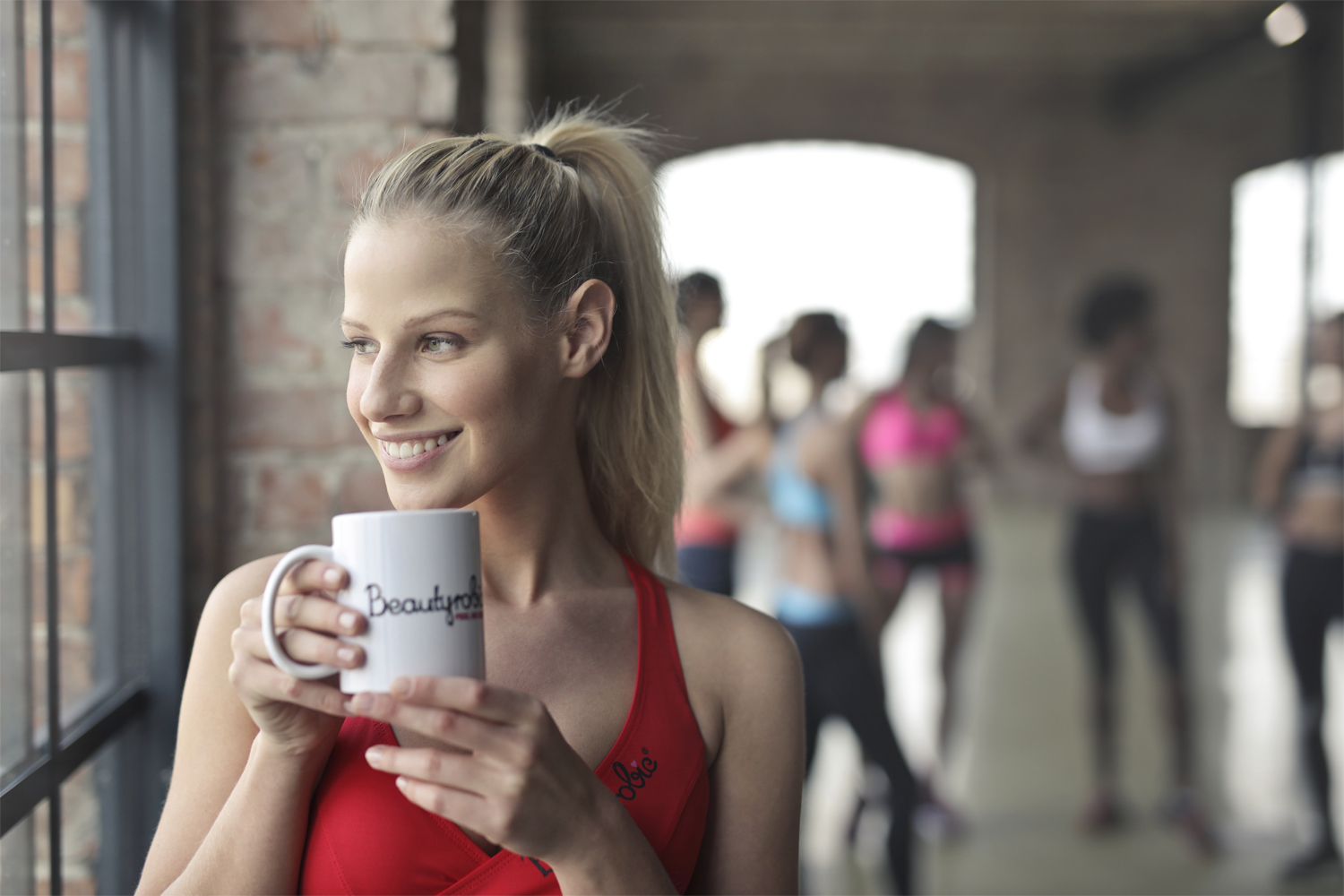 A woman drinking tea in the yoga studio