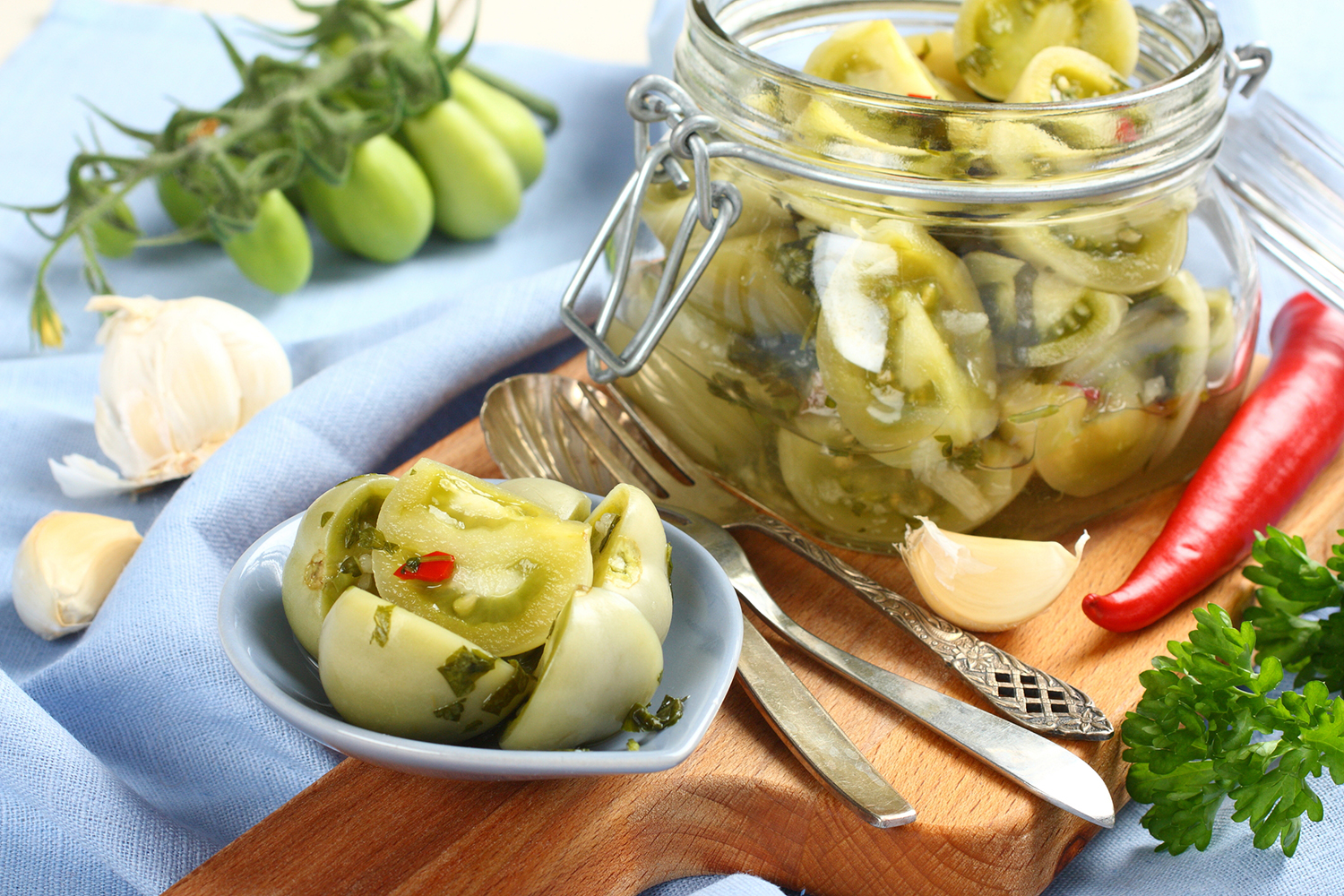 a jar of pickled green tomatoes
