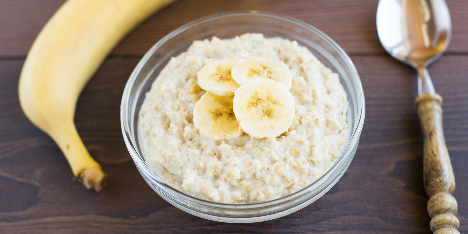 a bowl of porridge with cut banana on top