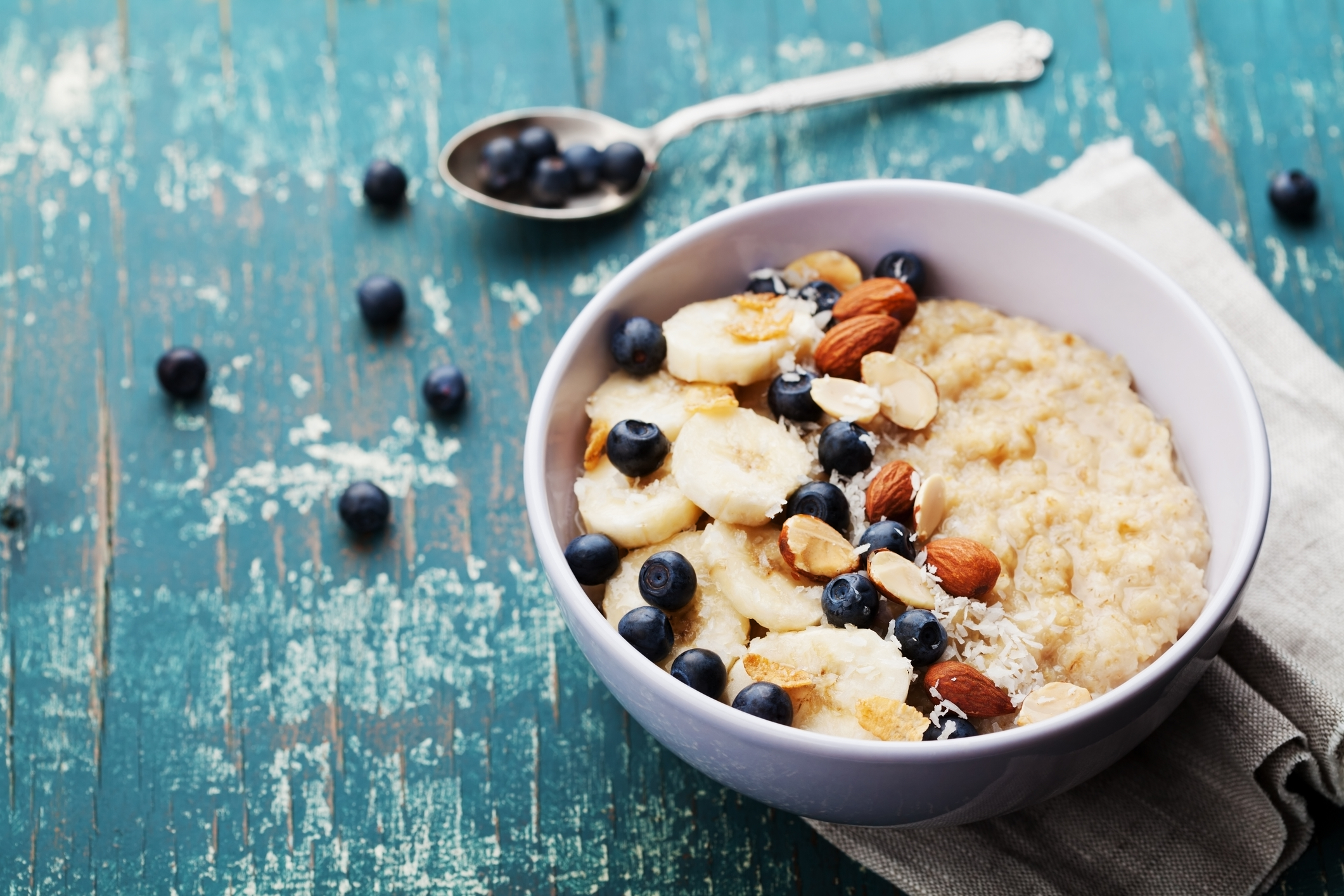 A bowl of oatmeal with blueberries and almonds. 