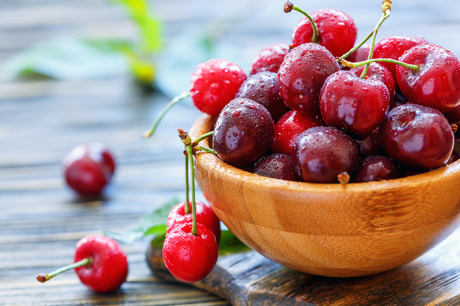 Red sweet cherries in a wooden bowl.