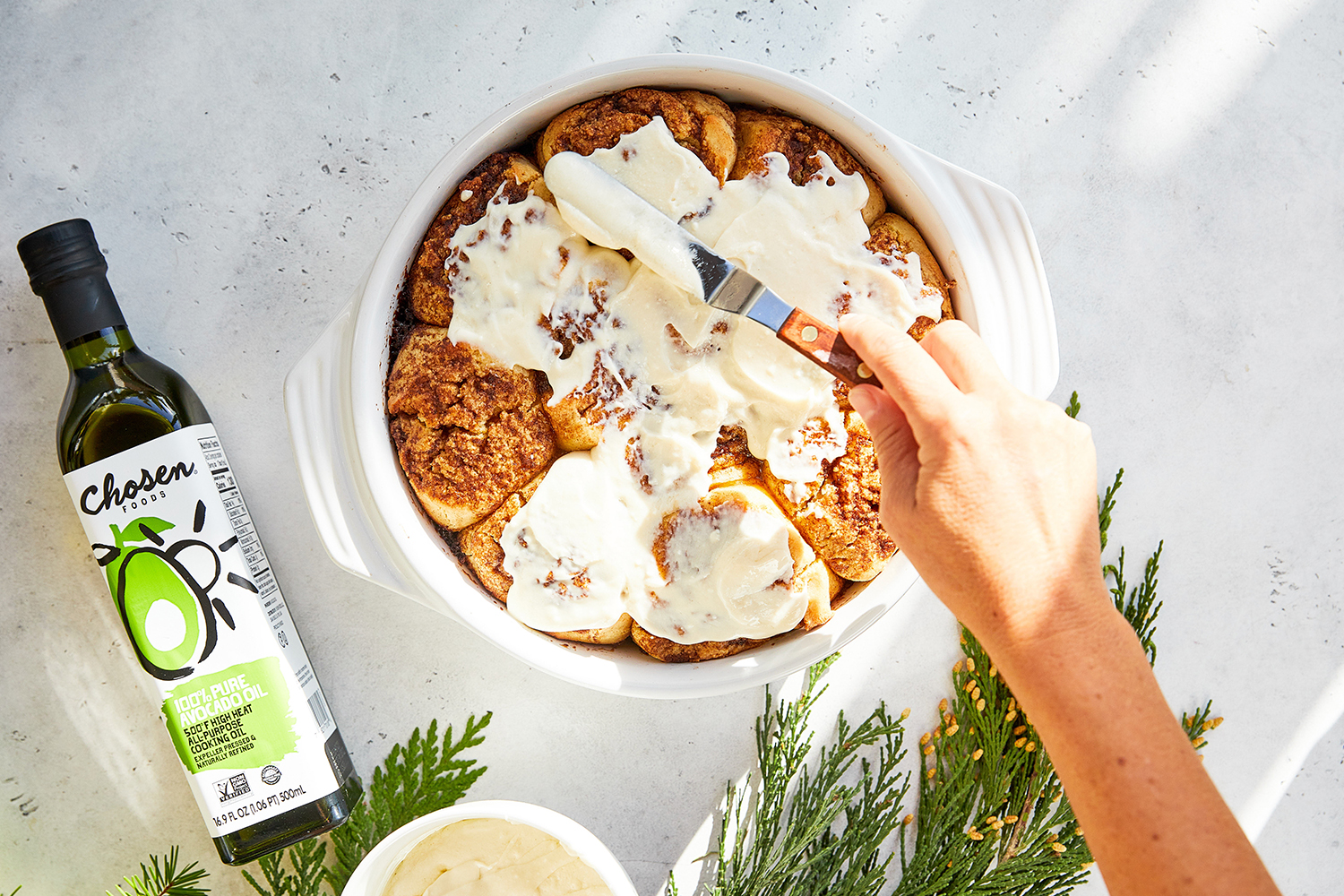 cinnamon buns being frosted