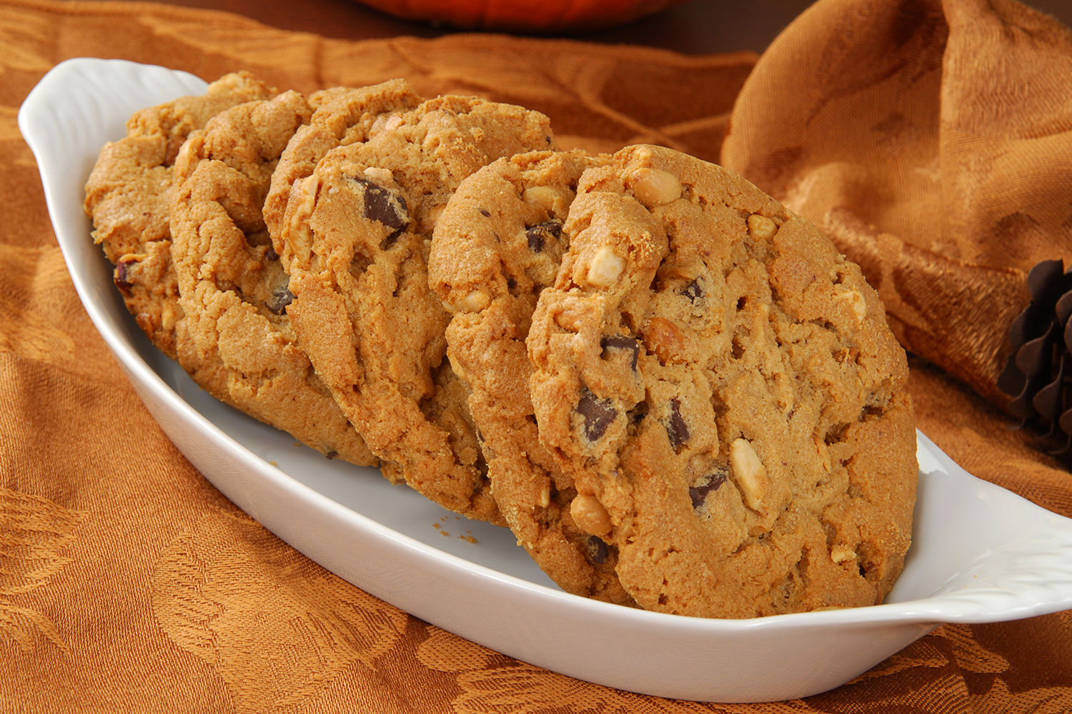 a dish of fresh chunky peanut butter cookies with chocolate chips