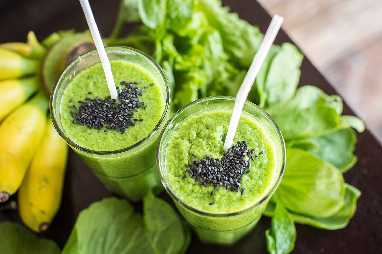 a green smoothie with spinach, bananas, and sesame seeds
