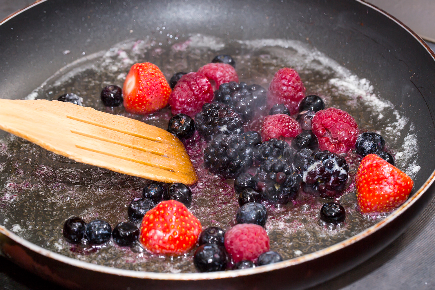 berries simmering in a pan to soften