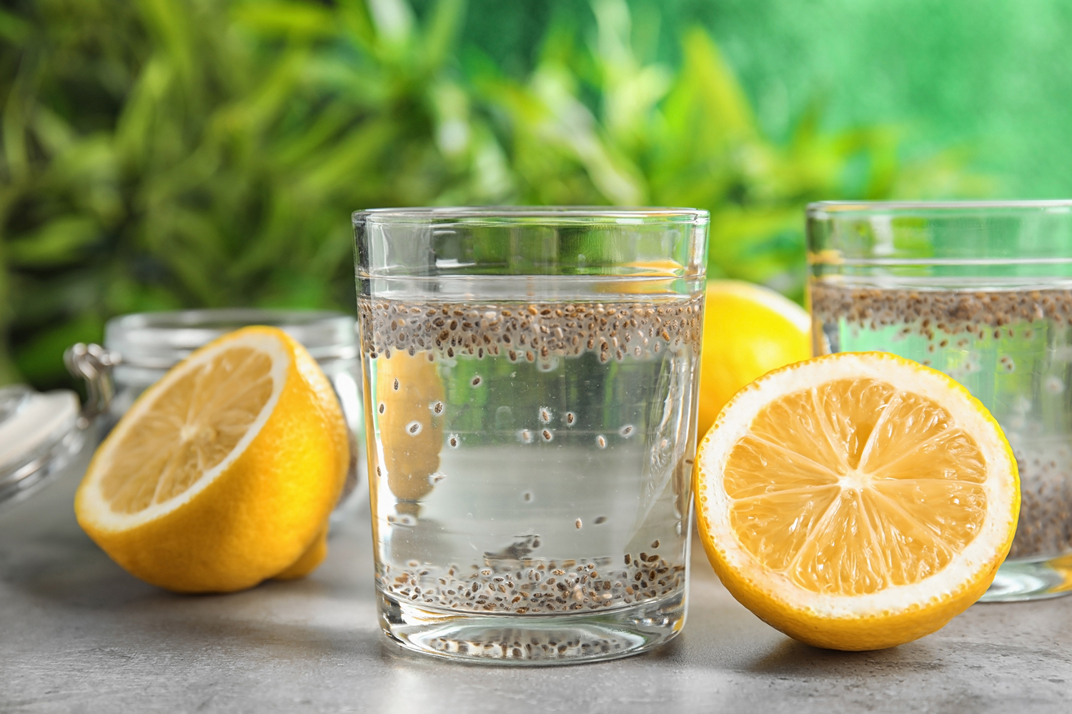 chia soaking in a glass of water with sliced lemons