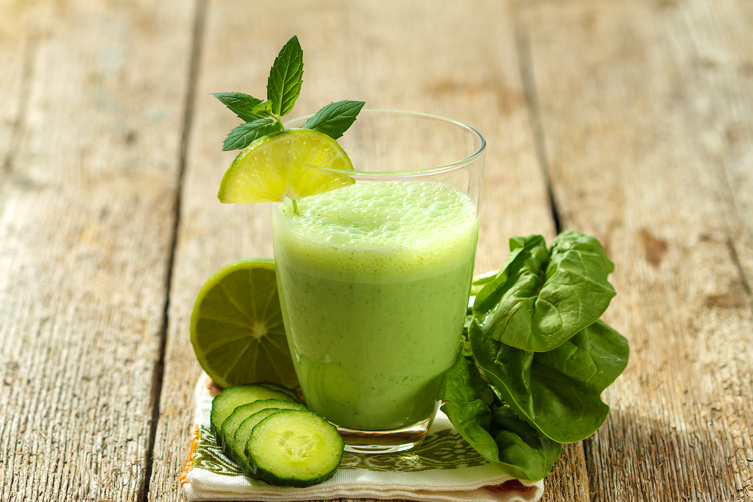 a smoothie made with cucumber, lime, and spinach