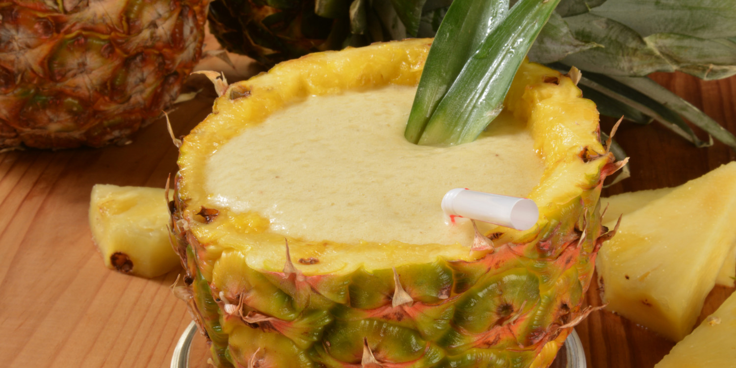 a smoothie served in a pineapple shell