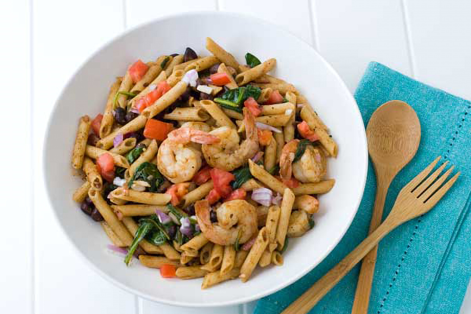 a bowl of seasoned penne and shrimp salad