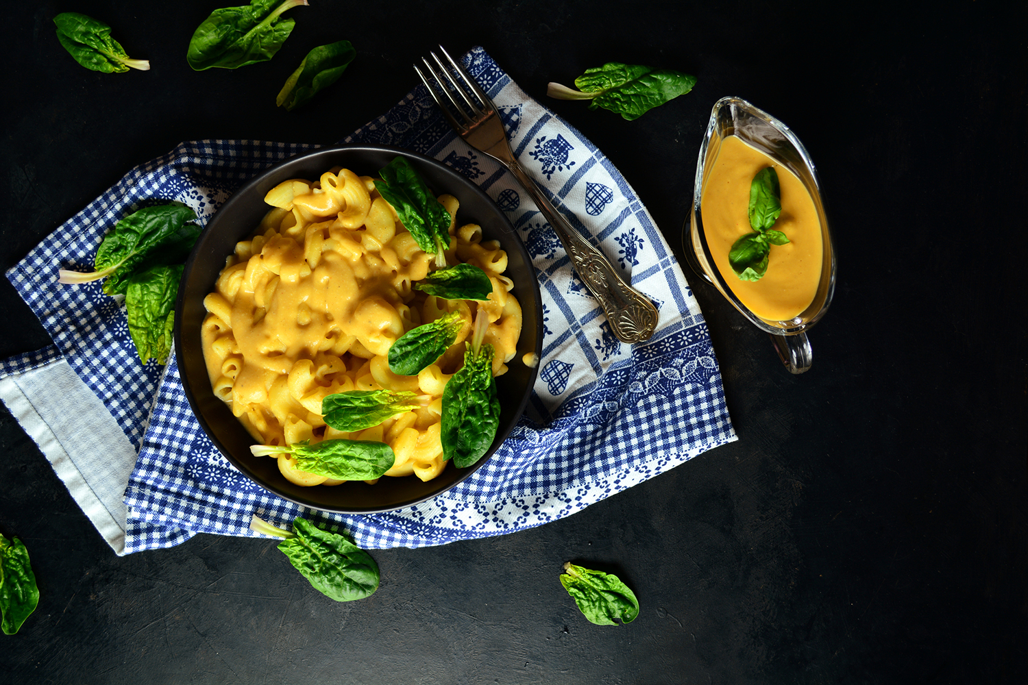 a bowl of vegan mac and cheese with extra cashew cheese on the side