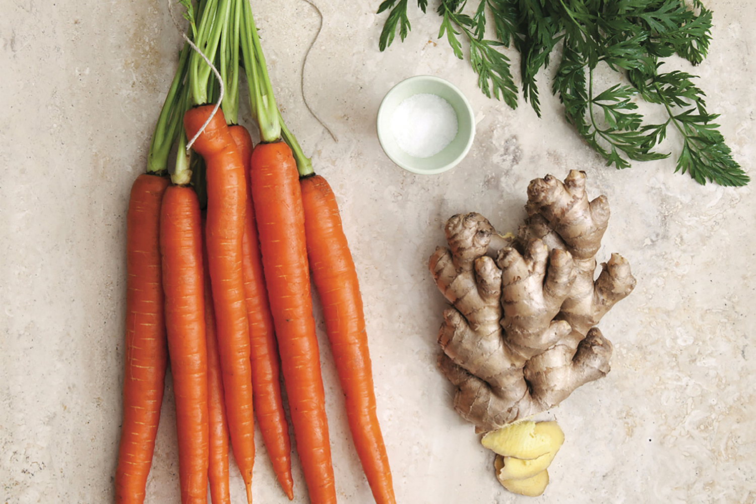 Carrots, ginger, and salt on a table