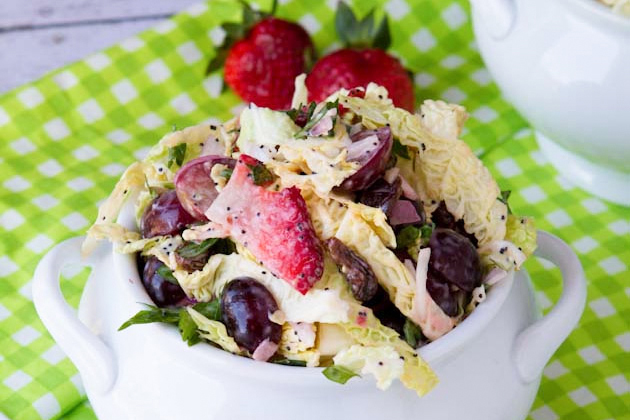 a dish of coleslaw with berries and seeds