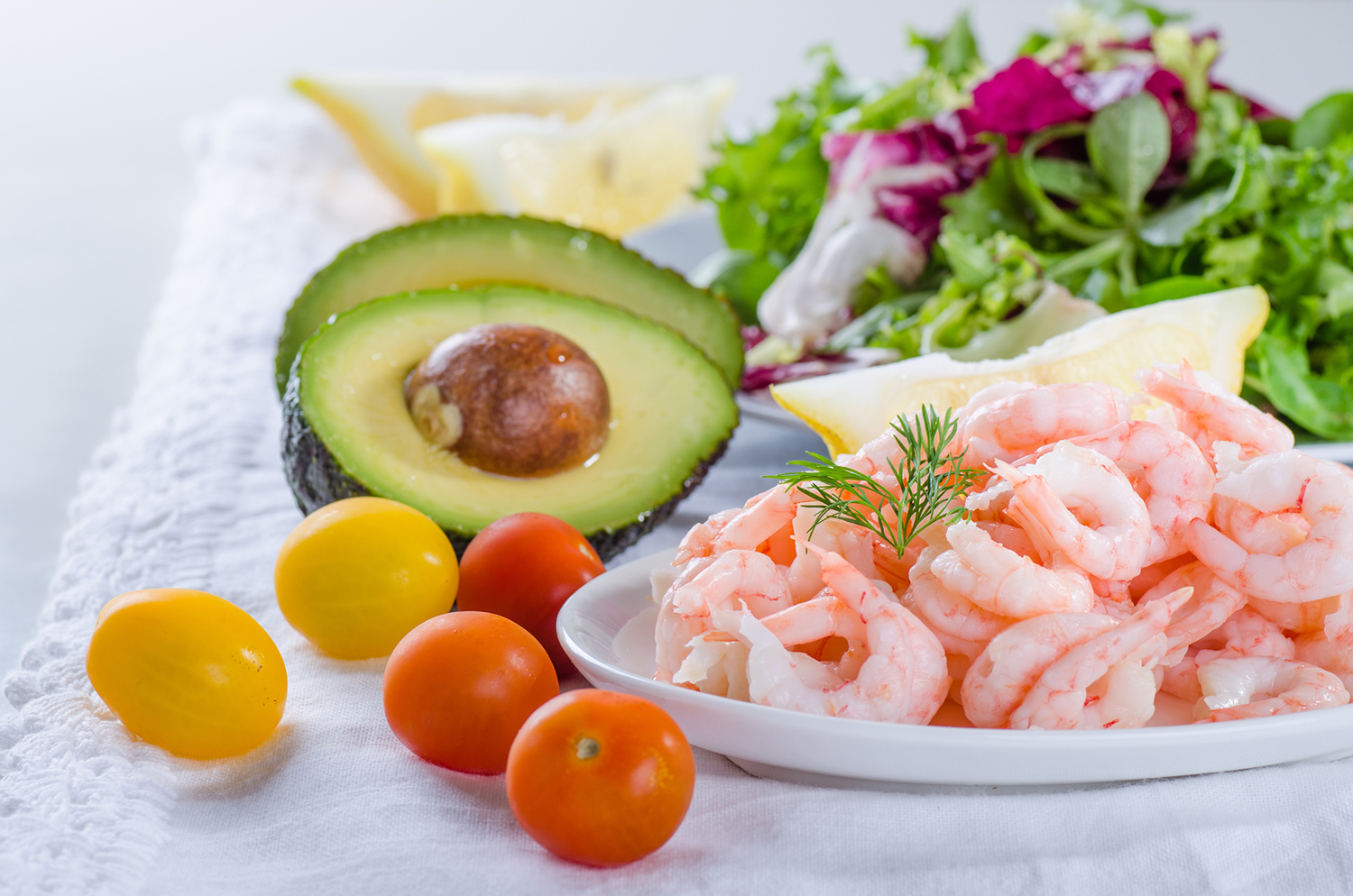 Shrimp and Avocado Paleo Salad ingredients, shrimp, tomato, avocado and lettuce.