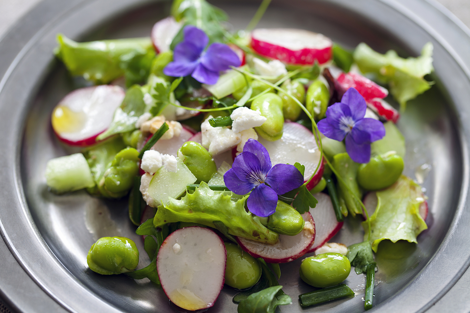 a fresh garden salad with violets