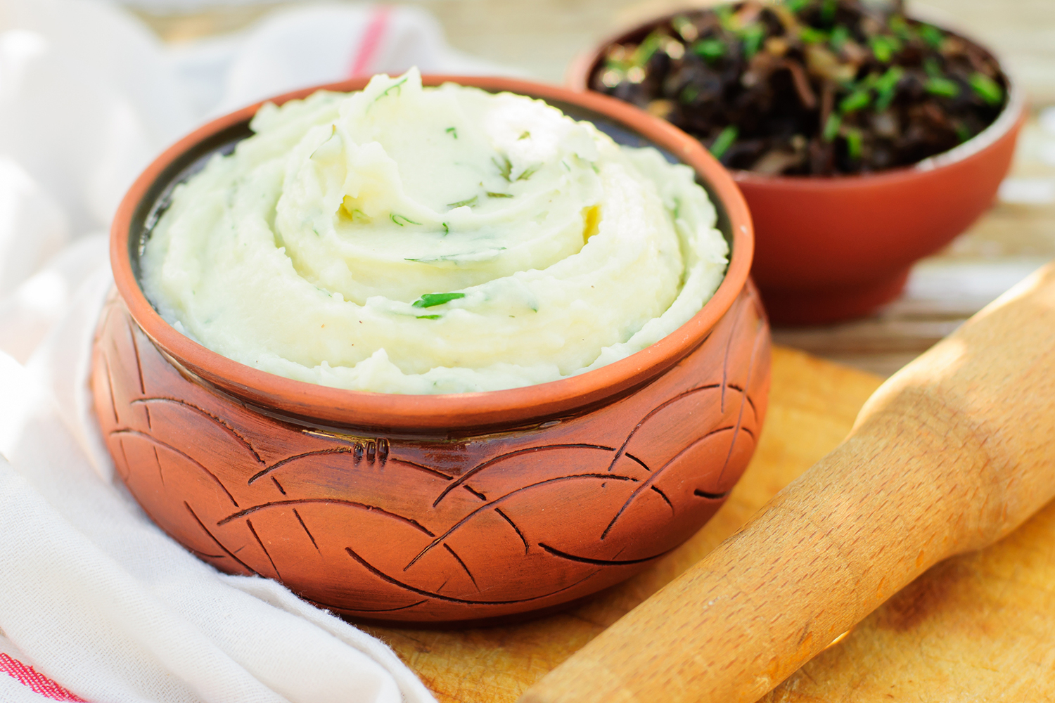 a bowl of mashed potatoes and herbs
