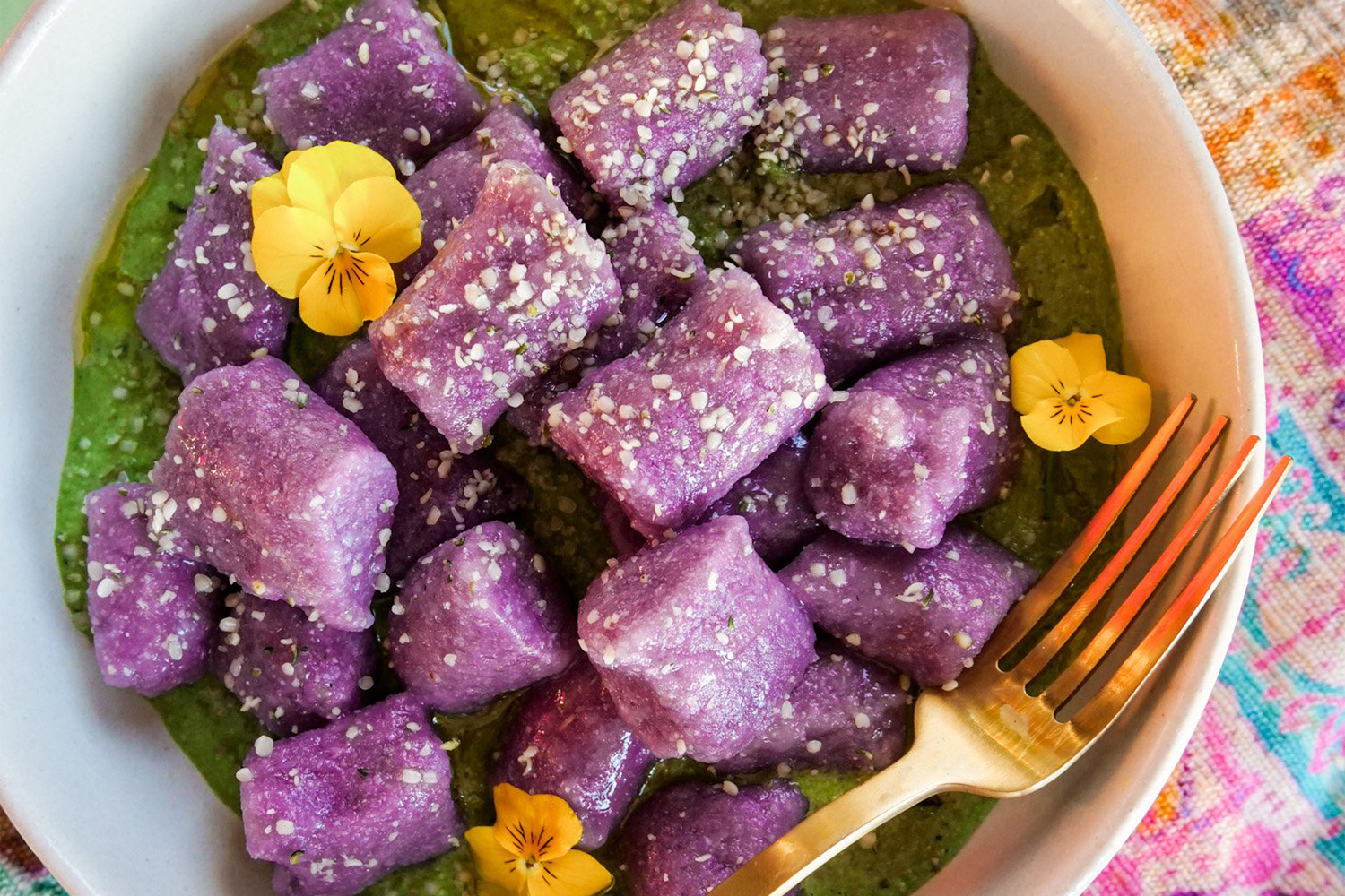 a bowl of cauliflower gnocchi on greens