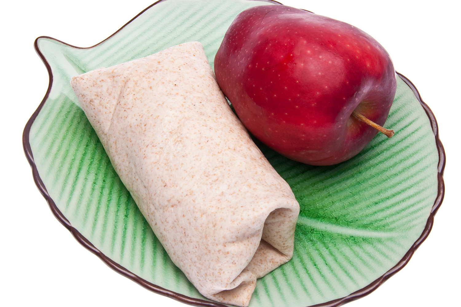 a wrap on a leafy green plate next to an apple