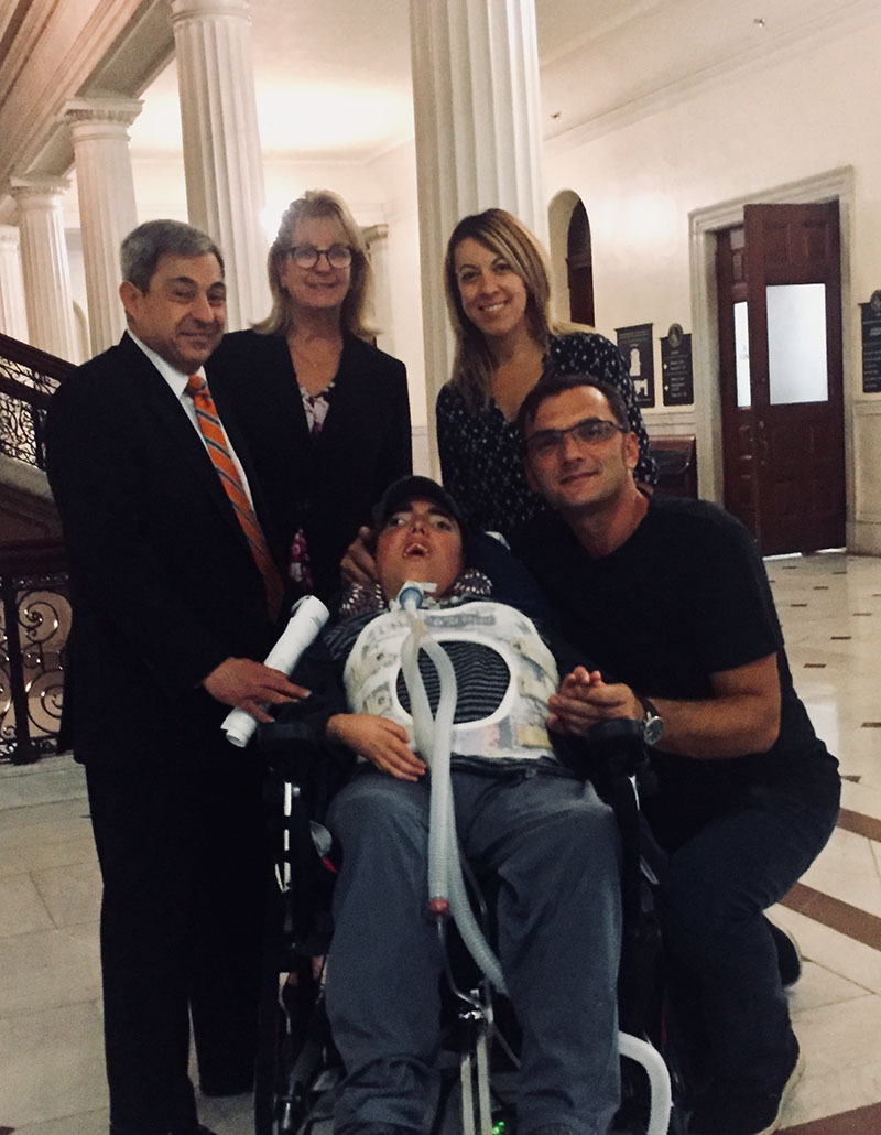 Jovan in the Massachusetts statehouse with politicians and advocates
