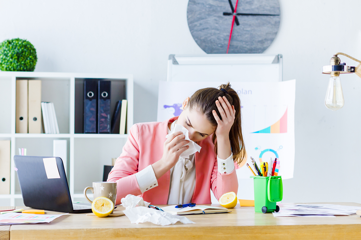 a young woman sick but at the office anyway