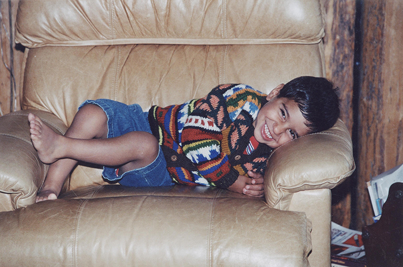 A smiling young boy on a couch
