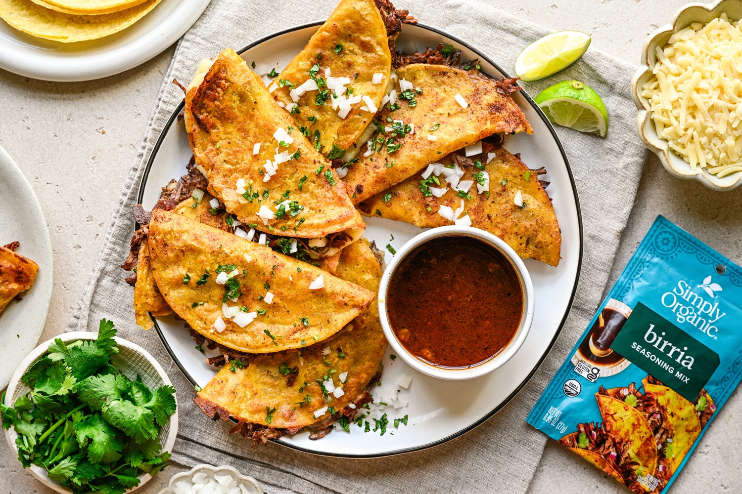 Birria Tacos on plate with dipping sauce and seasoning packet