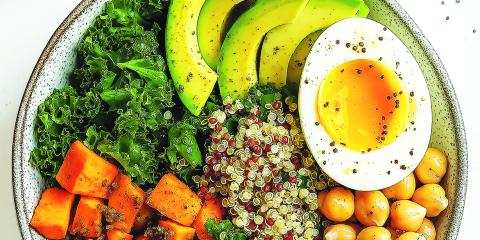 Kale, quinoa, chickpea and sweet potato salad in a bowl.