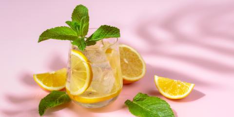 Glass of seltzer with fruit and mint. 