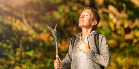 a spiritual woman enjoying a peacful moment while on an autumn hike