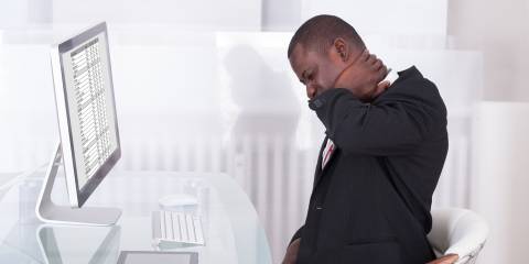 man at desk with neck pain