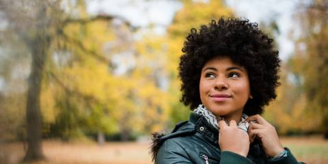 Candid shot of a young woman outdoors in autumn.