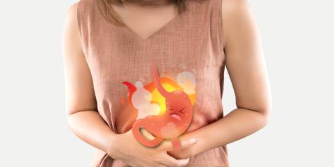 a woman suffering heartburn from an angry stomach