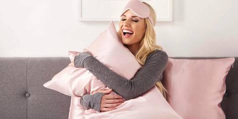 a woman hugging her pillows