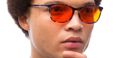 a man wearing a pair of sunglasses that block harmful blue light