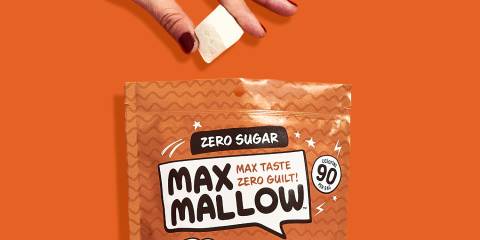 a woman snacking on a bag of marshmellows