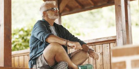 a healthy-looking older man meditating on life