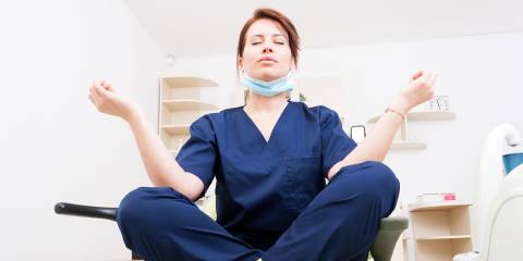 a young nurse meditating in the exam room