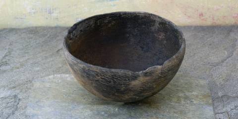 a misshapen bowl on a weathered slab