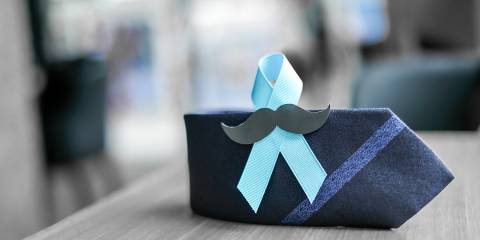 an awareness ribbon on a tie with a fake mustache