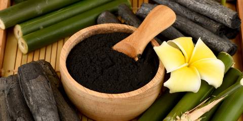 Activated Charcoal in a wooden bowl.
