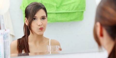 a woman rinsing her mouth with oil